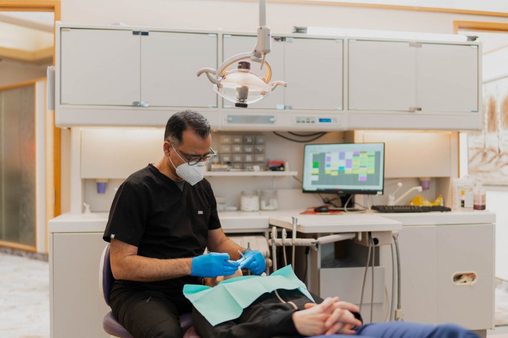 Dr. Moez Lakhani with Patient | Millennium Dental | General & Family Dentist | SE Calgary