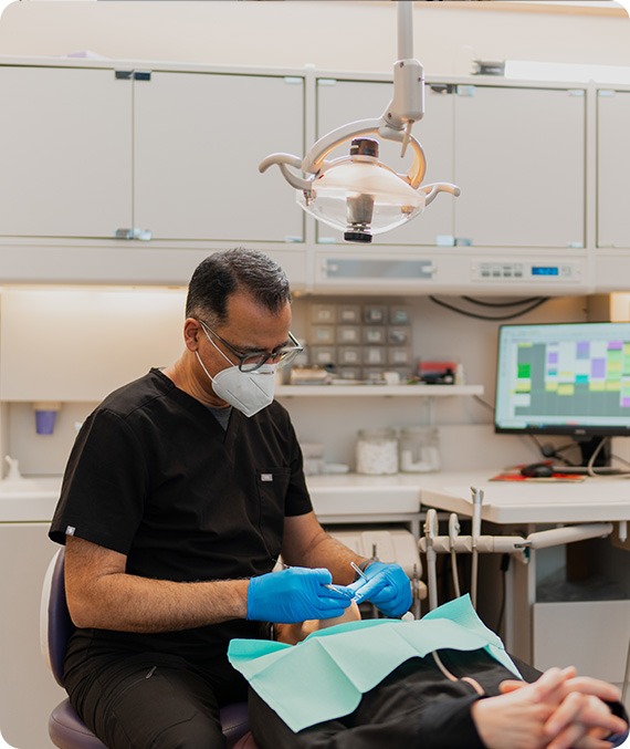 Dr. Moez Lakhani with a Patient | Millennium Dental | General & Family Dentist | SE Calgary
